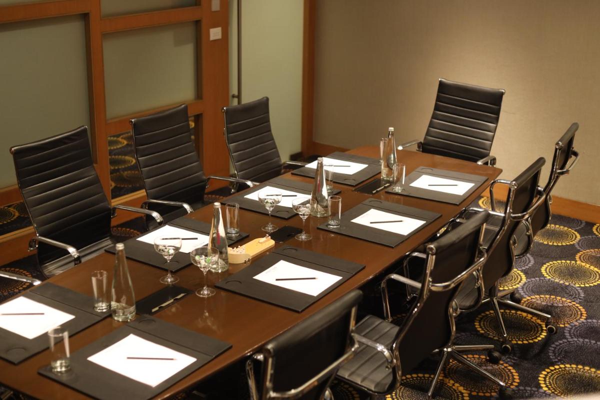 a large conference room with a long table and chairs at Novotel Pune Viman Nagar Road in Pune