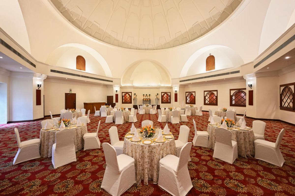 a large banquet hall with tables and chairs in a room at Ambassador, New Delhi - IHCL SeleQtions in New Delhi a large banquet hall with tables and chairs in a room at Ambassador, New Delhi - IHCL SeleQtions in New Delhi