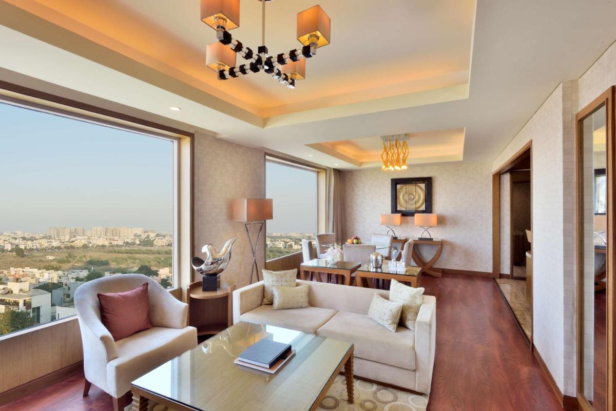 a living room with a couch and a table at Radisson Blu Hotel, Indore in Indore