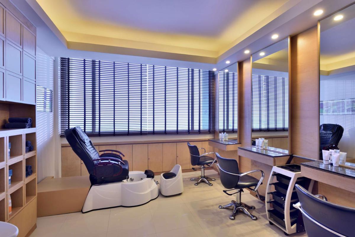 a hair salon with chairs and a barber shop at Radisson Blu Hotel, Indore in Indore