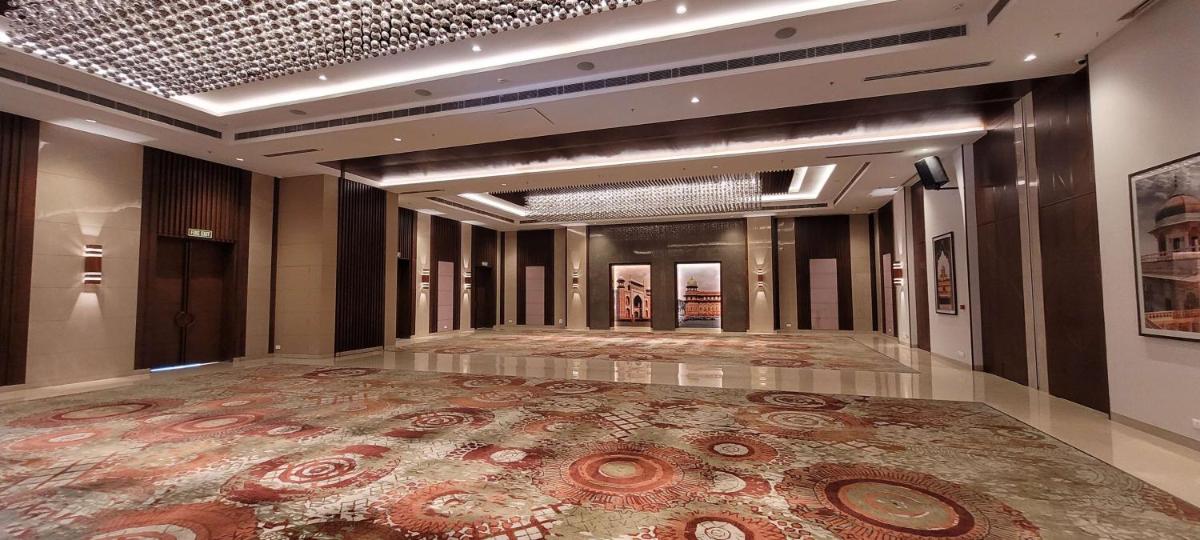 a lobby with a large rug on the floor at Radisson Blu Hotel, Greater Noida in Greater Noida