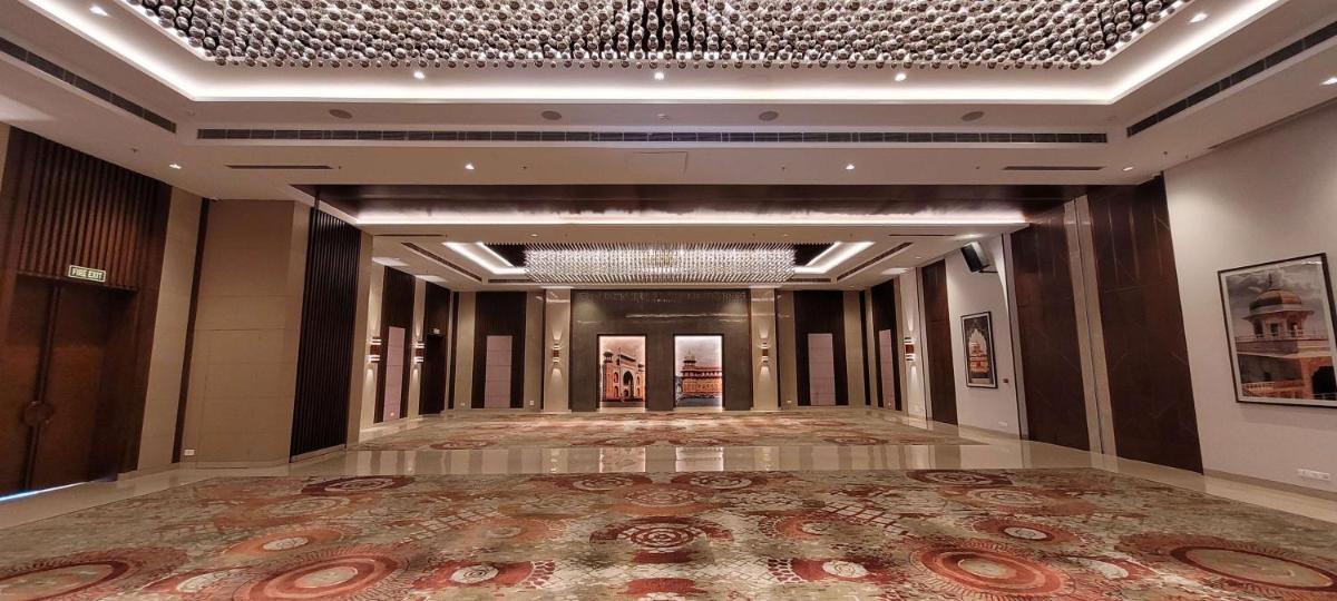 a hallway of a building with a large rug at Radisson Blu Hotel, Greater Noida in Greater Noida