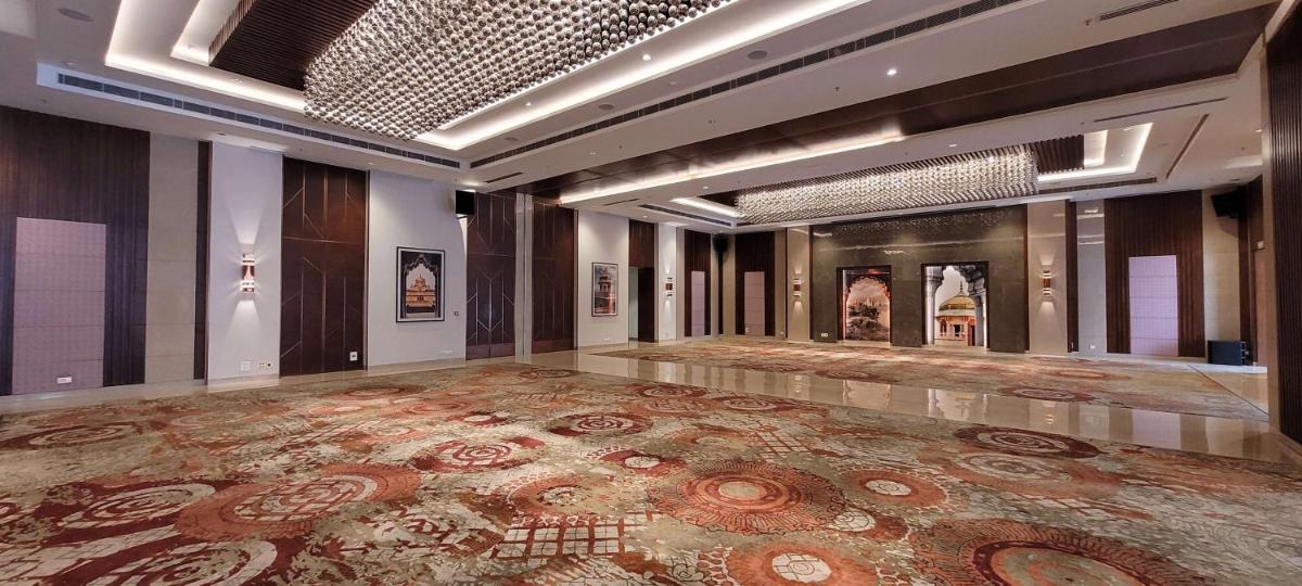 a large room with a large rug on the floor at Radisson Blu Hotel, Greater Noida in Greater Noida