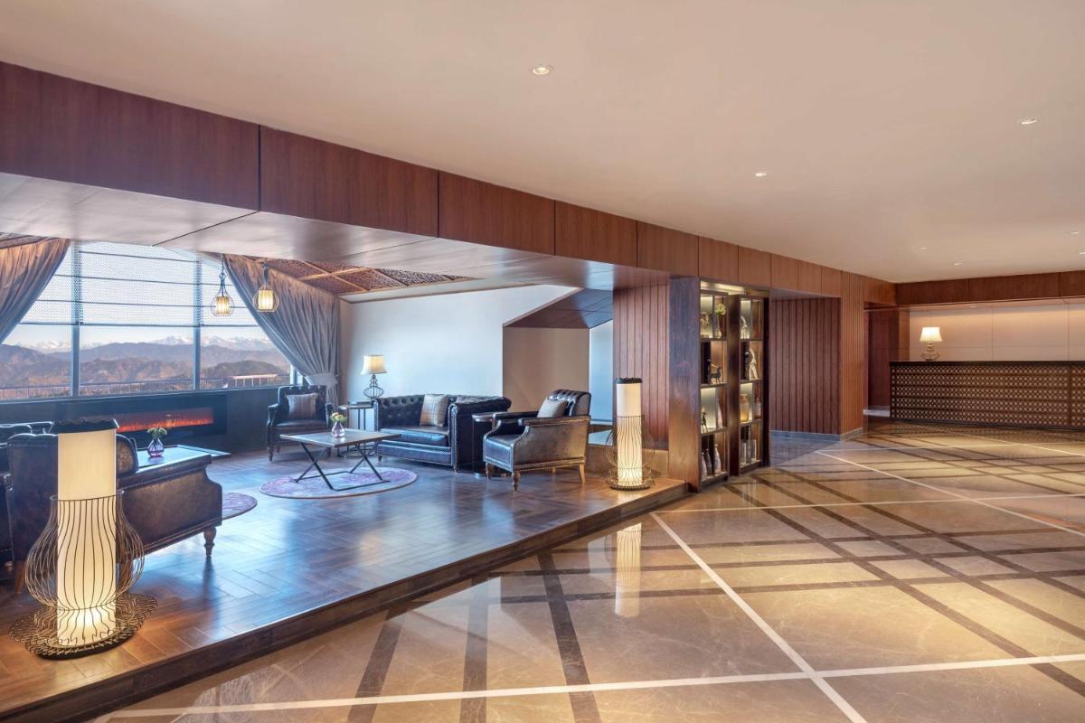 a lobby of a hotel with a living room at Radisson Kufri in Shimla
