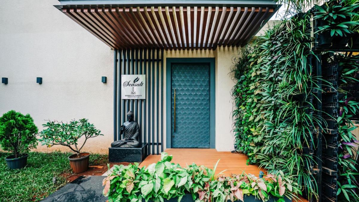 a statue sitting on a bench in front of a building at Holiday Inn Goa Candolim in Candolim a statue sitting on a bench in front of a building at Holiday Inn Goa Candolim in Candolim