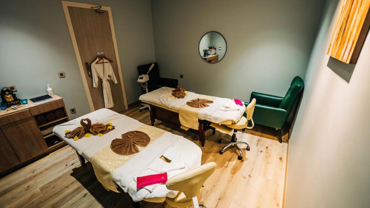 a hospital room with two beds and a mirror at Holiday Inn Goa Candolim in Candolim a hospital room with two beds and a mirror at Holiday Inn Goa Candolim in Candolim