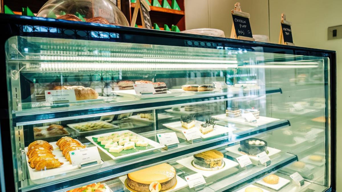 a display case filled with different types of pastries at Holiday Inn Goa Candolim in Candolim a display case filled with different types of pastries at Holiday Inn Goa Candolim in Candolim