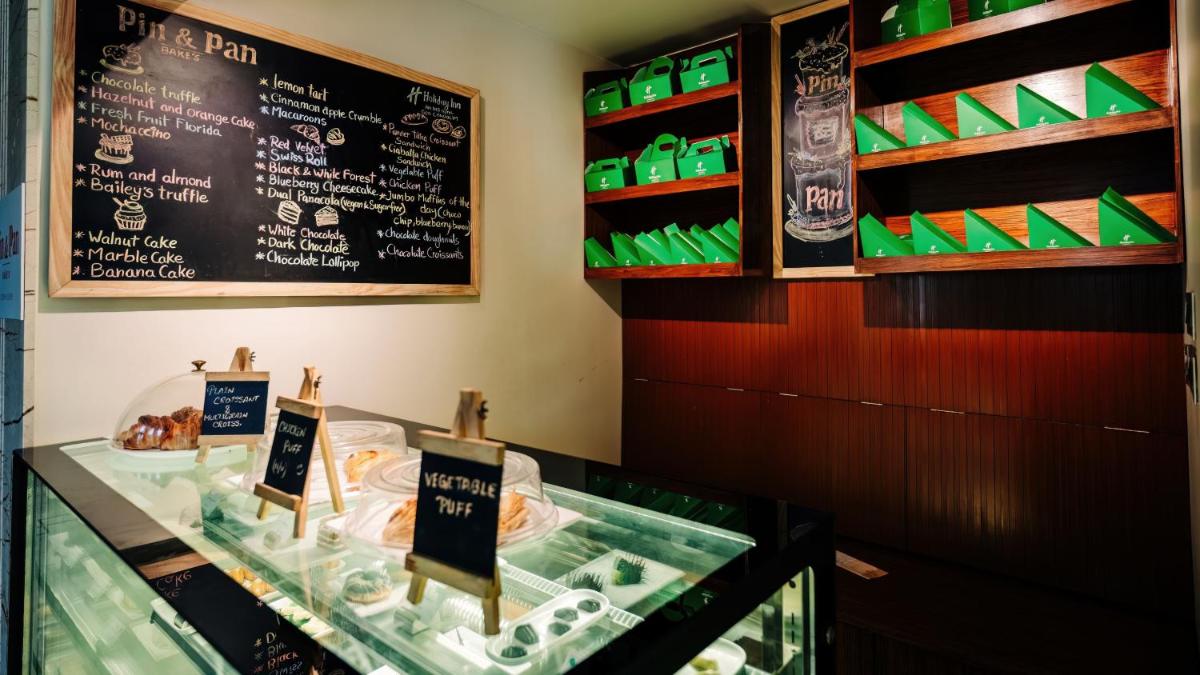 a display case in a restaurant with a chalkboard at Holiday Inn Goa Candolim in Candolim a display case in a restaurant with a chalkboard at Holiday Inn Goa Candolim in Candolim