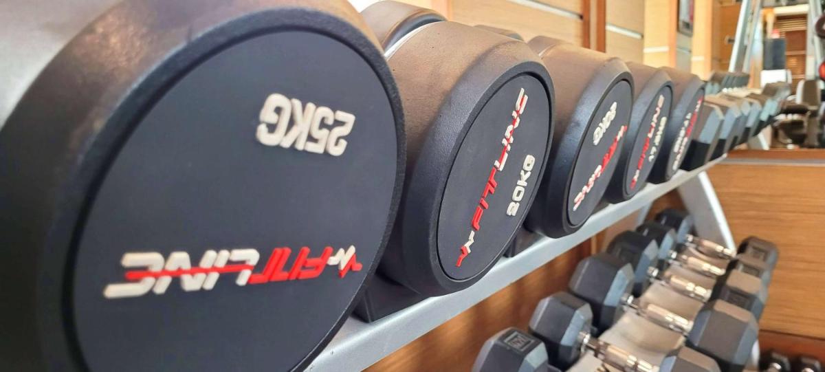 a row of black clocks on a shelf at Radisson Blu Hotel, Greater Noida in Greater Noida