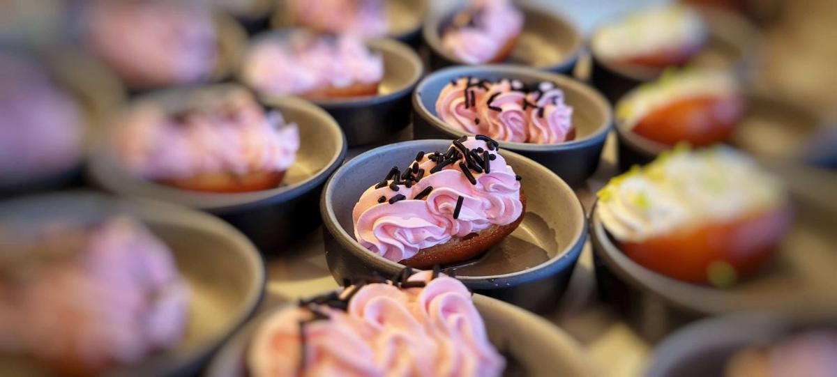 a bunch of cupcakes with pink frosting and sprinkles at Radisson Blu Hotel, Greater Noida in Greater Noida