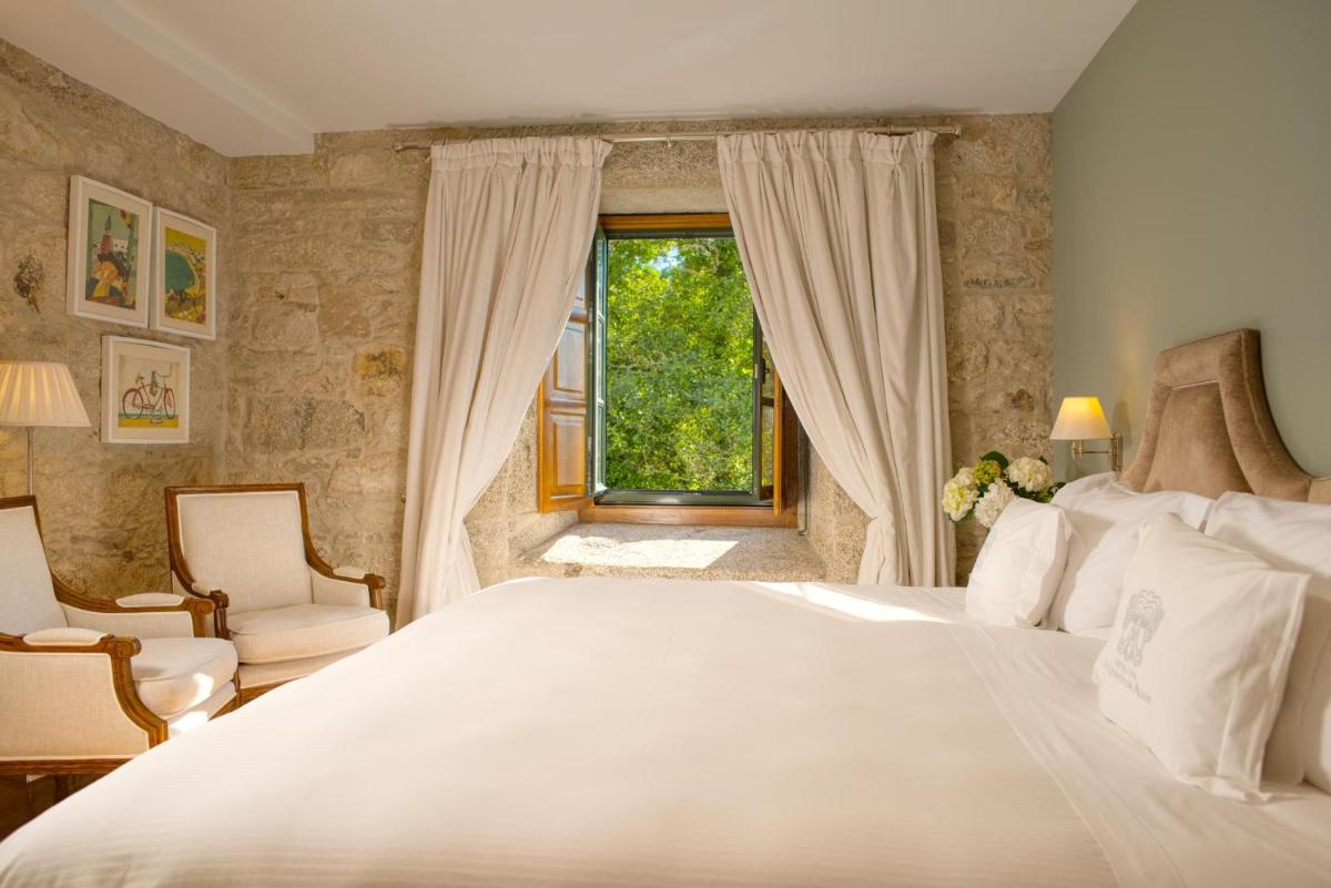 Cama o camas de una habitación en A Quinta Da Auga Hotel Spa Relais & Chateaux