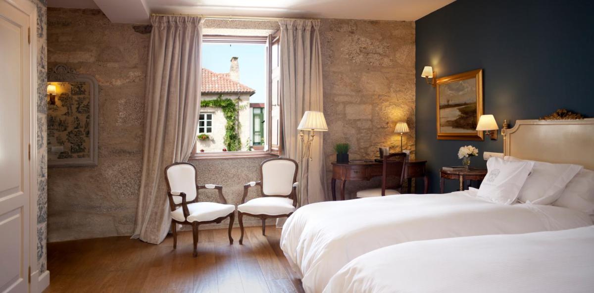 Cama o camas de una habitación en A Quinta Da Auga Hotel Spa Relais & Chateaux