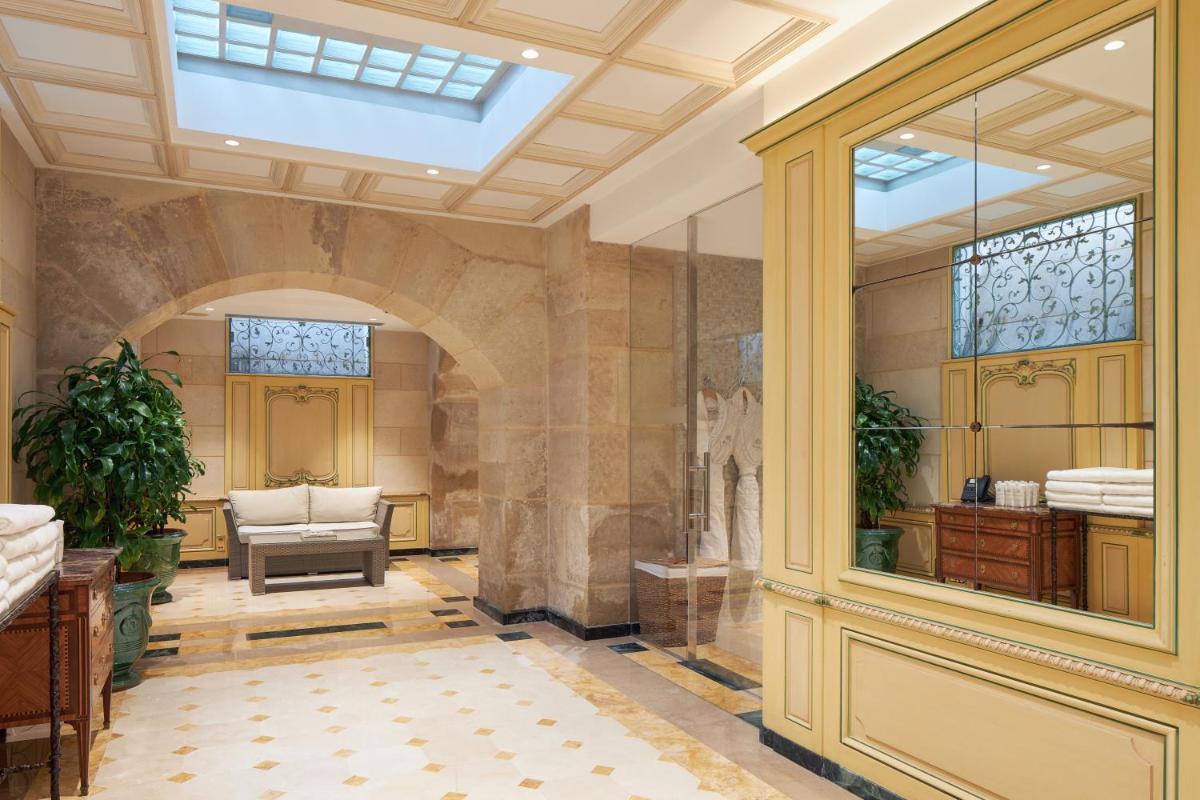 une grande chambre avec un hall et un bâtiment dans l'établissement Hôtel Regina Louvre, à Paris