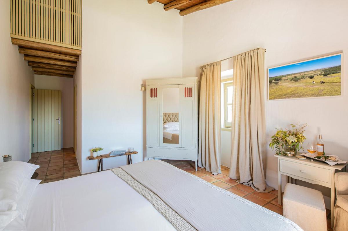 Uma cama ou camas num quarto em Herdade da Malhadinha Nova - Relais & Châteaux