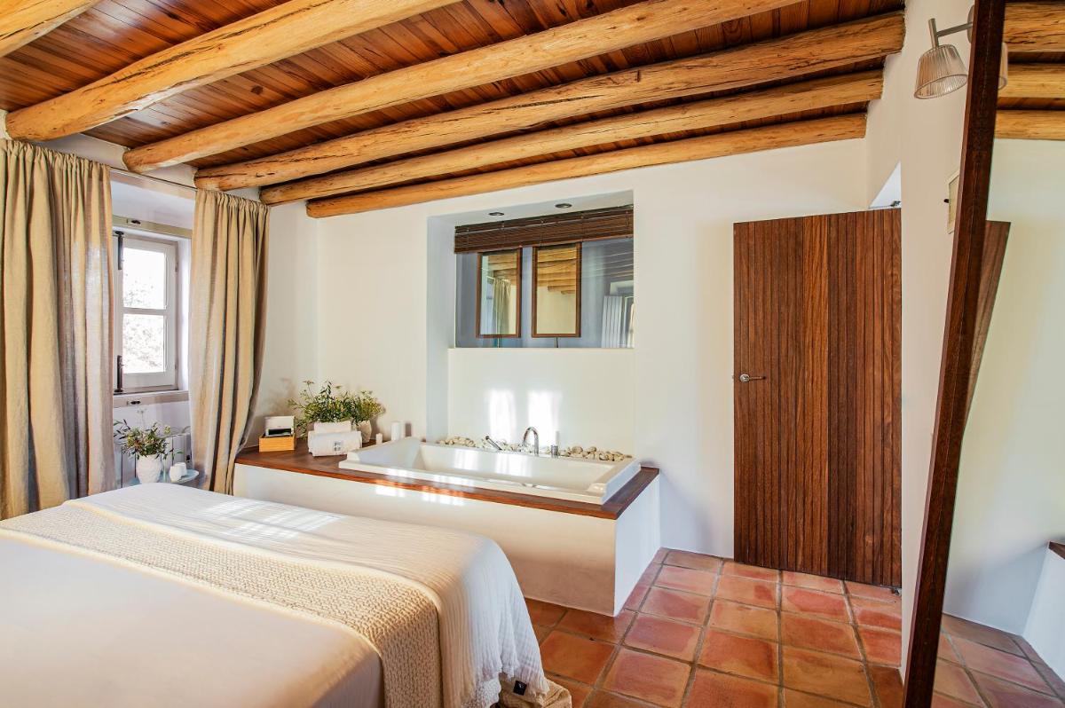 Uma cama ou camas num quarto em Herdade da Malhadinha Nova - Relais & Châteaux
