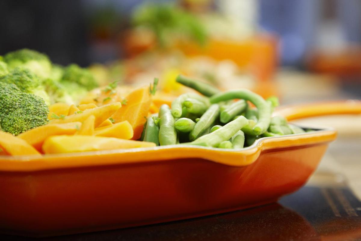 an orange bowl of vegetables on a table at Taj Ganges Varanasi in Varanasi