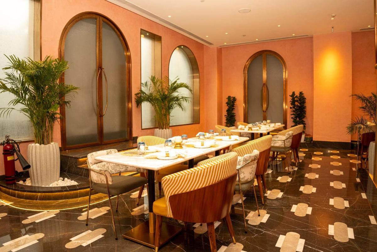 a dining room with a long table and chairs at Crowne Plaza Today Gurugram by IHG in Gurgaon