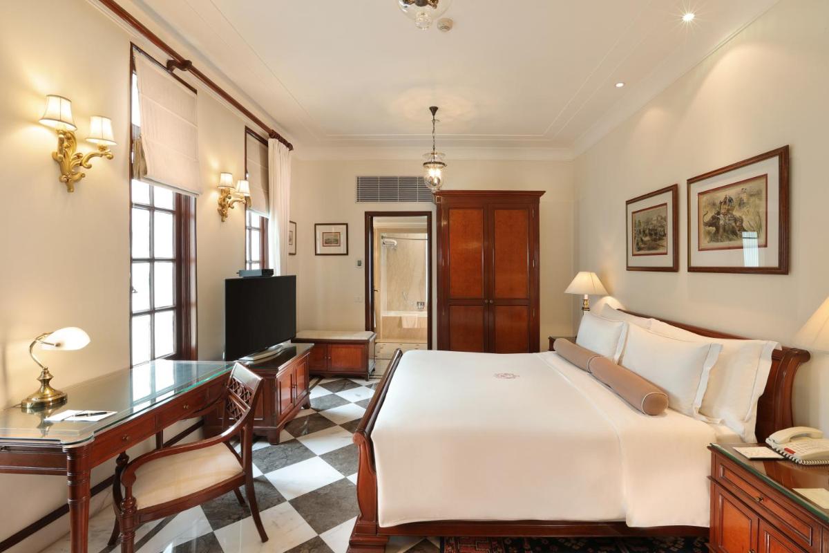 a hotel room with a bed and a desk and a desk at The Imperial, New Delhi in New Delhi a hotel room with a bed and a desk and a desk at The Imperial, New Delhi in New Delhi