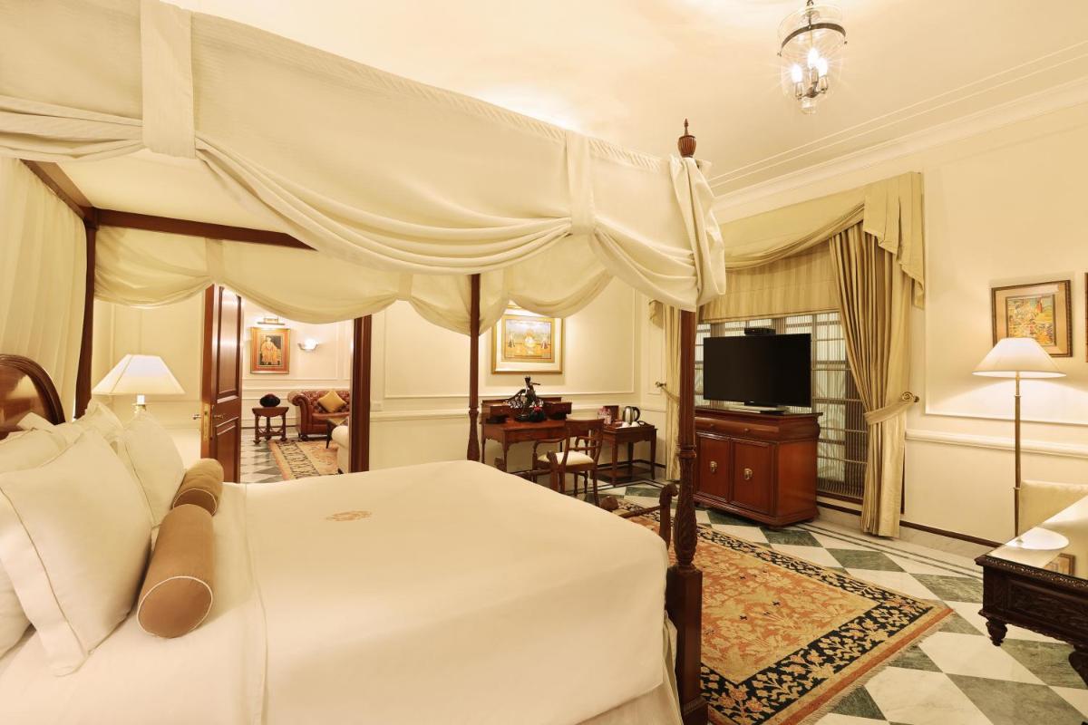 a bedroom with a canopy bed and a living room at The Imperial, New Delhi in New Delhi a bedroom with a canopy bed and a living room at The Imperial, New Delhi in New Delhi