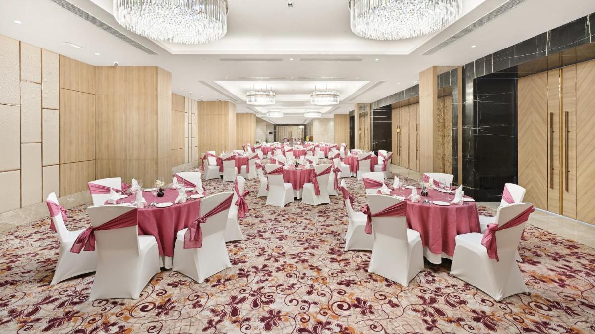 a banquet hall with tables and chairs in a room at Holiday Inn Gurugram Sector 90 by IHG in Gurgaon