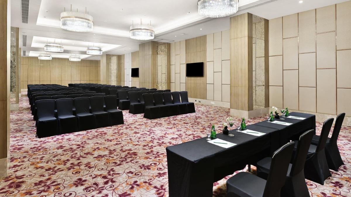a room with rows of tables and chairs in a room at Holiday Inn Gurugram Sector 90 by IHG in Gurgaon