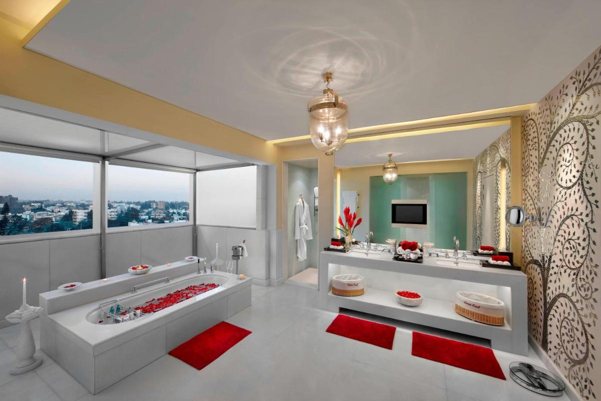 a bathroom with a large tub and a large window at ITC Gardenia, a Luxury Collection Hotel, Bengaluru in Bengaluru a bathroom with a large tub and a large window at ITC Gardenia, a Luxury Collection Hotel, Bengaluru in Bengaluru