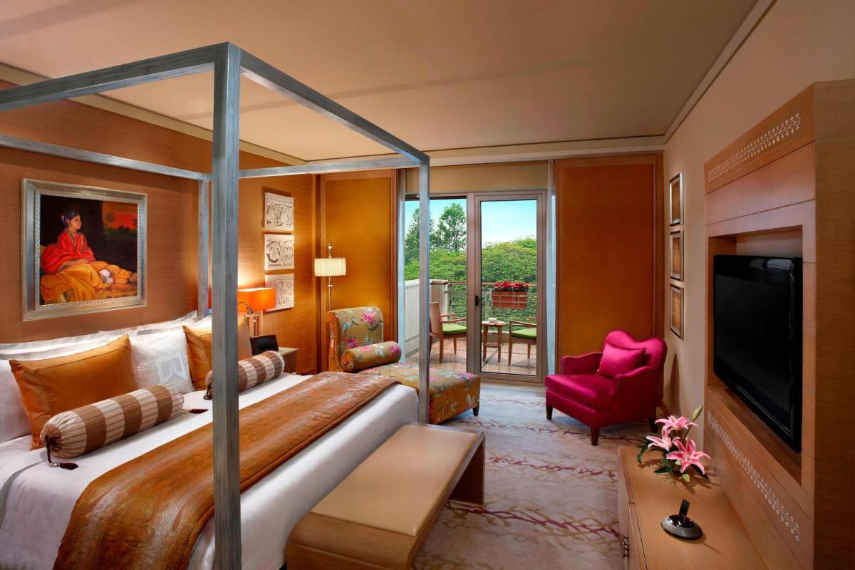 a bedroom with a canopy bed and a living room at ITC Gardenia, a Luxury Collection Hotel, Bengaluru in Bengaluru a bedroom with a canopy bed and a living room at ITC Gardenia, a Luxury Collection Hotel, Bengaluru in Bengaluru