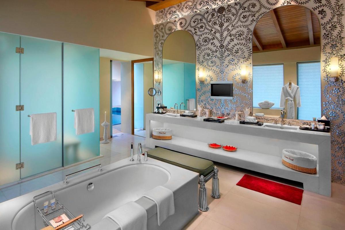 a large bathroom with a tub and a tv at ITC Gardenia, a Luxury Collection Hotel, Bengaluru in Bengaluru a large bathroom with a tub and a tv at ITC Gardenia, a Luxury Collection Hotel, Bengaluru in Bengaluru