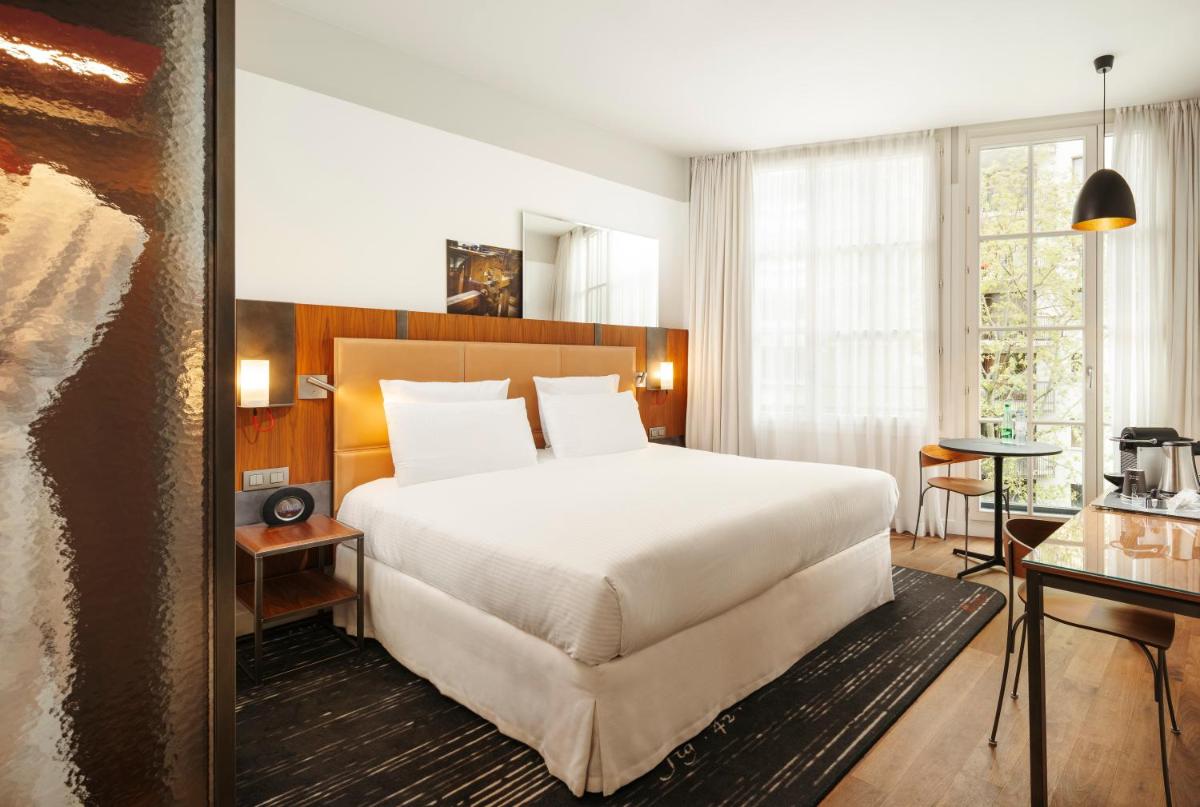 Un ou plusieurs lits dans un hébergement de l'établissement Boutet Bastille Hotel Paris - MGallery Collection
