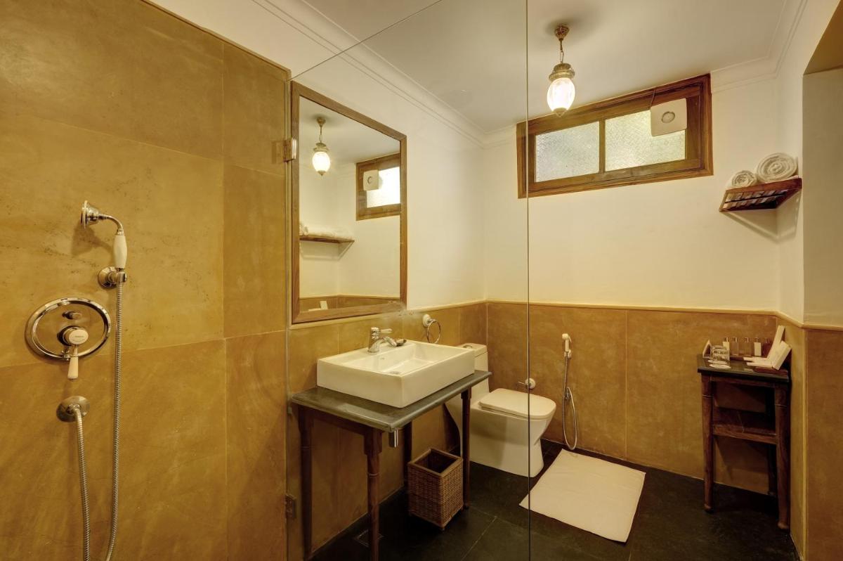 a bathroom with a sink and a shower and a toilet at Saraca Hotel Lucknow in Lucknow