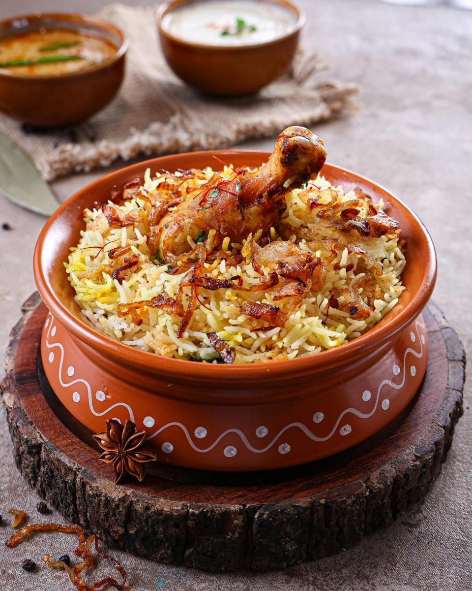 a bowl of rice with a chicken on top at Sheraton Hyderabad Hotel in Hyderabad