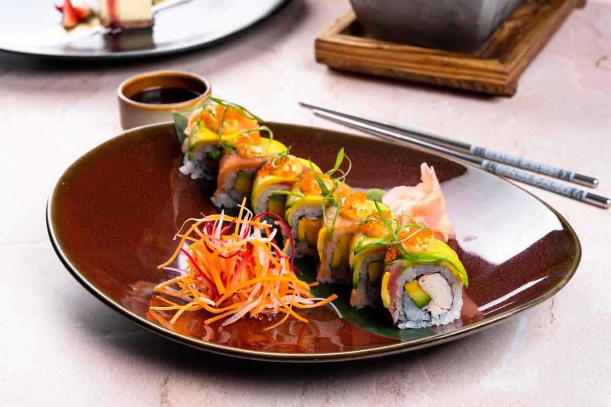 a plate of food with sushi on a table at Sheraton Hyderabad Hotel in Hyderabad