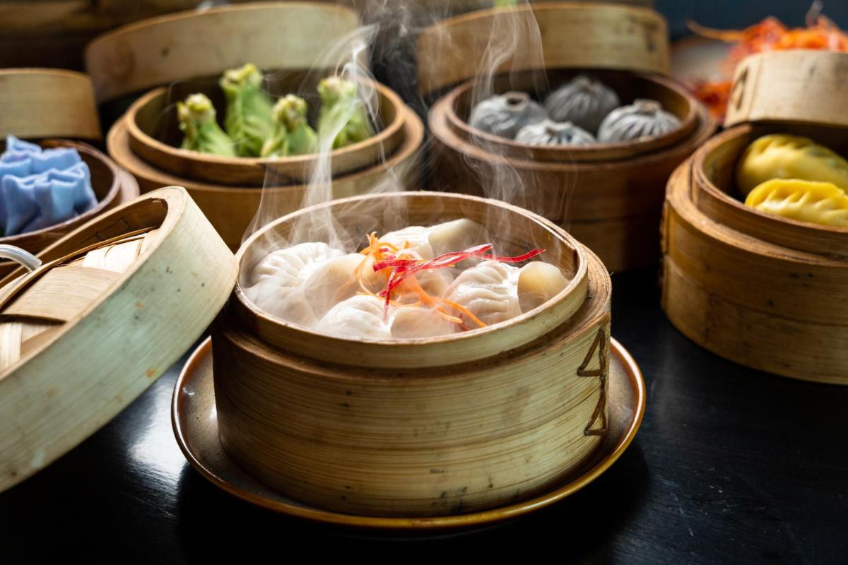 a wooden bowl filled with food on a table at Sheraton Hyderabad Hotel in Hyderabad