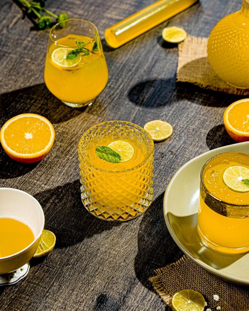 a table with glasses of orange juice and orange slices at Sheraton Hyderabad Hotel in Hyderabad