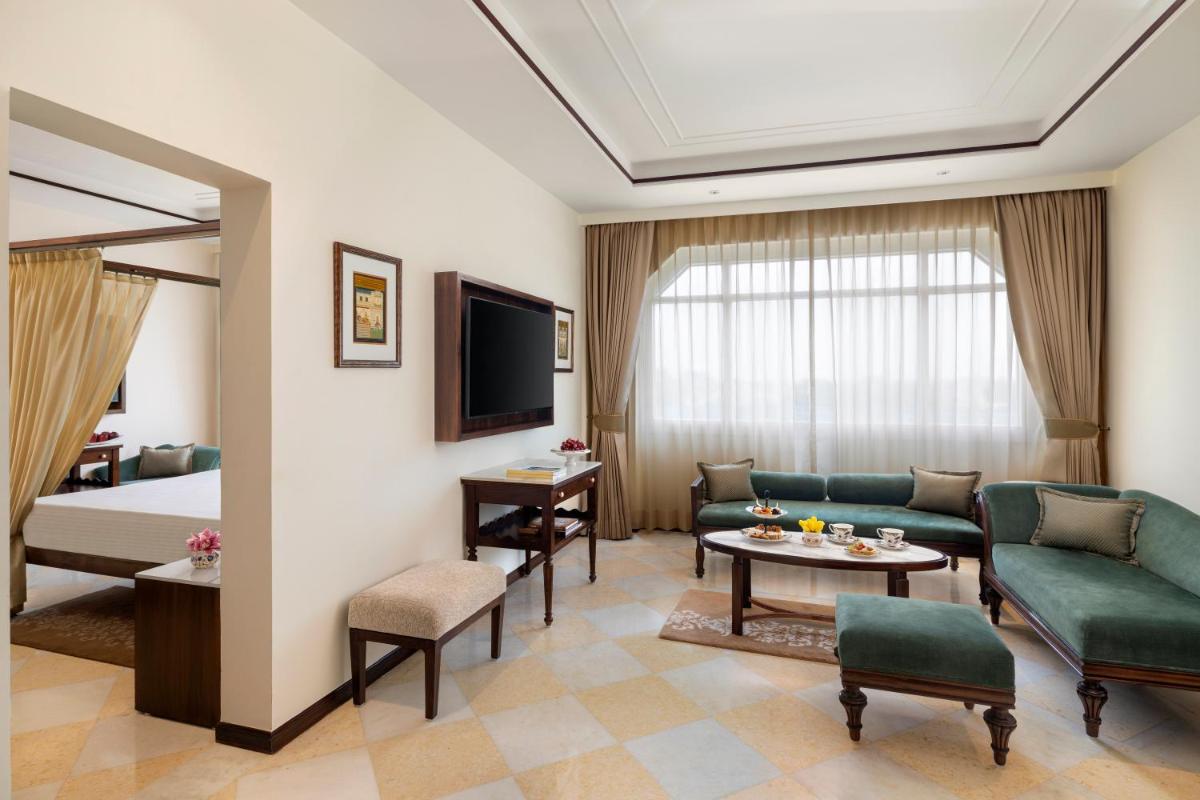 a hotel room with a bed and a living room at Tajview, Agra-IHCL SeleQtions in Agra