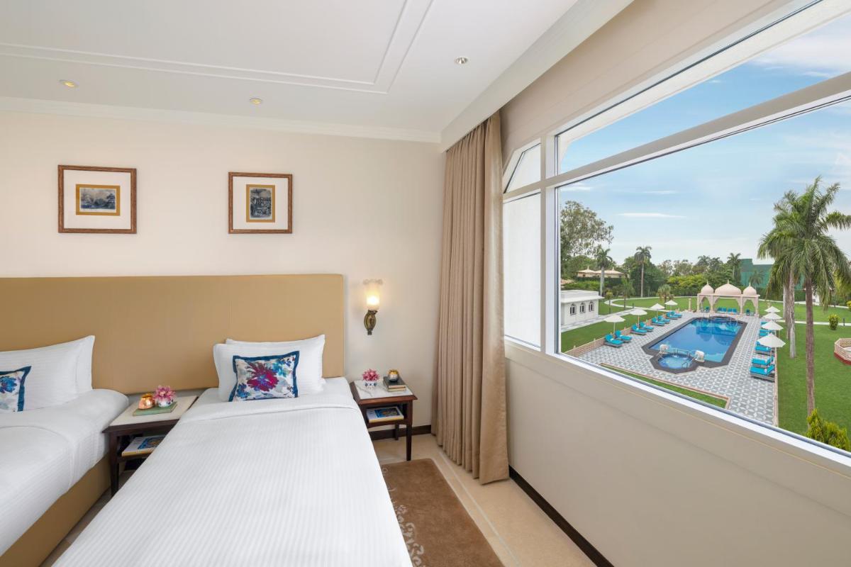 a hotel room with two beds and a window at Tajview, Agra-IHCL SeleQtions in Agra