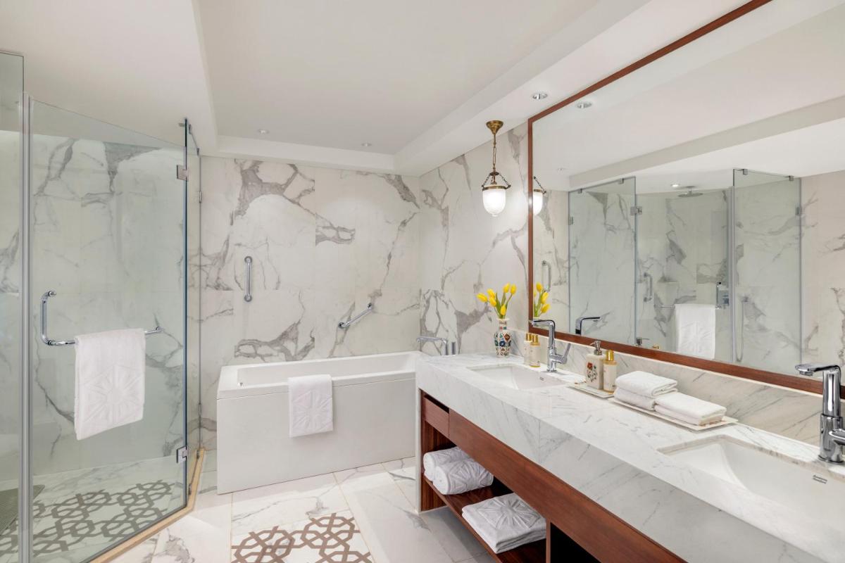 a bathroom with a tub and a sink and a shower at Tajview, Agra-IHCL SeleQtions in Agra