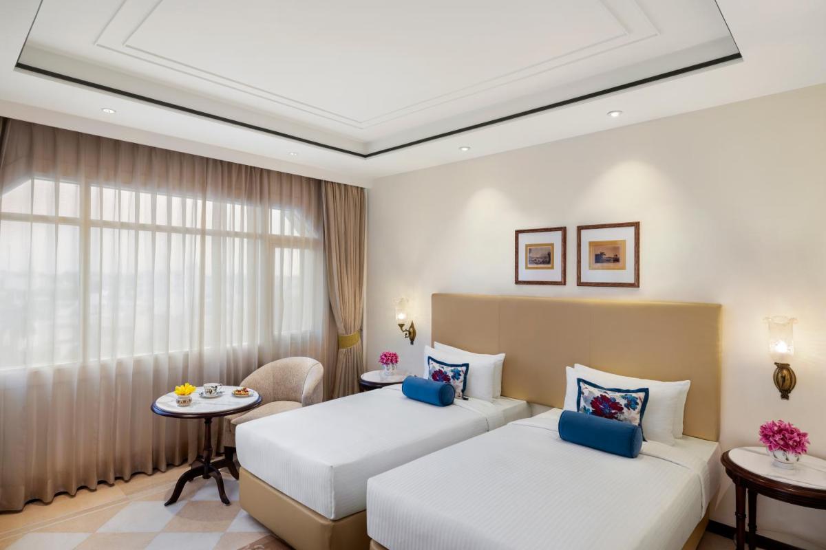 a hotel room with two beds and a table at Tajview, Agra-IHCL SeleQtions in Agra