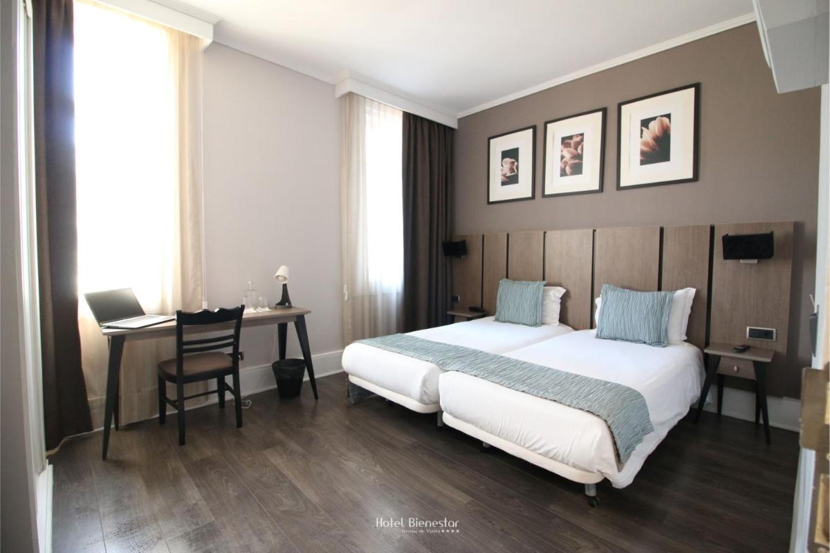 Uma cama ou camas num quarto em Hotel Bienestar Termas De Vizela