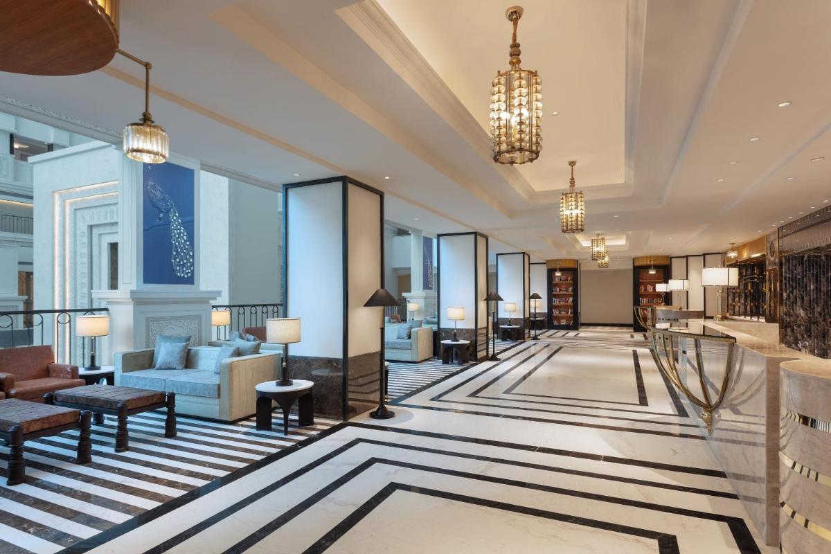 a lobby of a hotel with a couch and chairs at ITC Narmada, a Luxury Collection Hotel, Ahmedabad in Ahmedabad