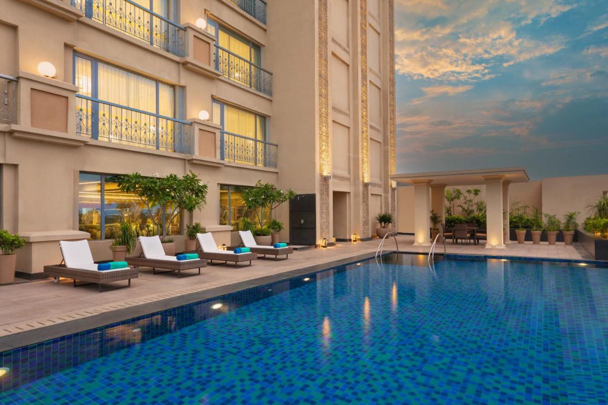 a swimming pool in front of a building at ITC Narmada, a Luxury Collection Hotel, Ahmedabad in Ahmedabad