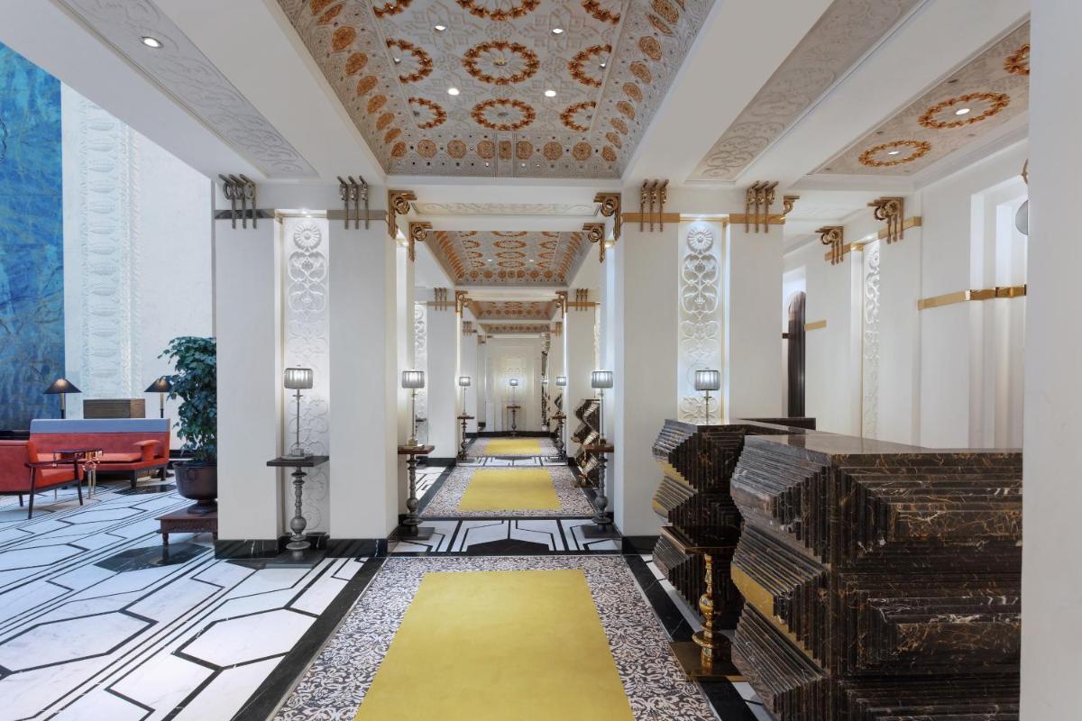 a hallway with a yellow carpet in a building at ITC Narmada, a Luxury Collection Hotel, Ahmedabad in Ahmedabad