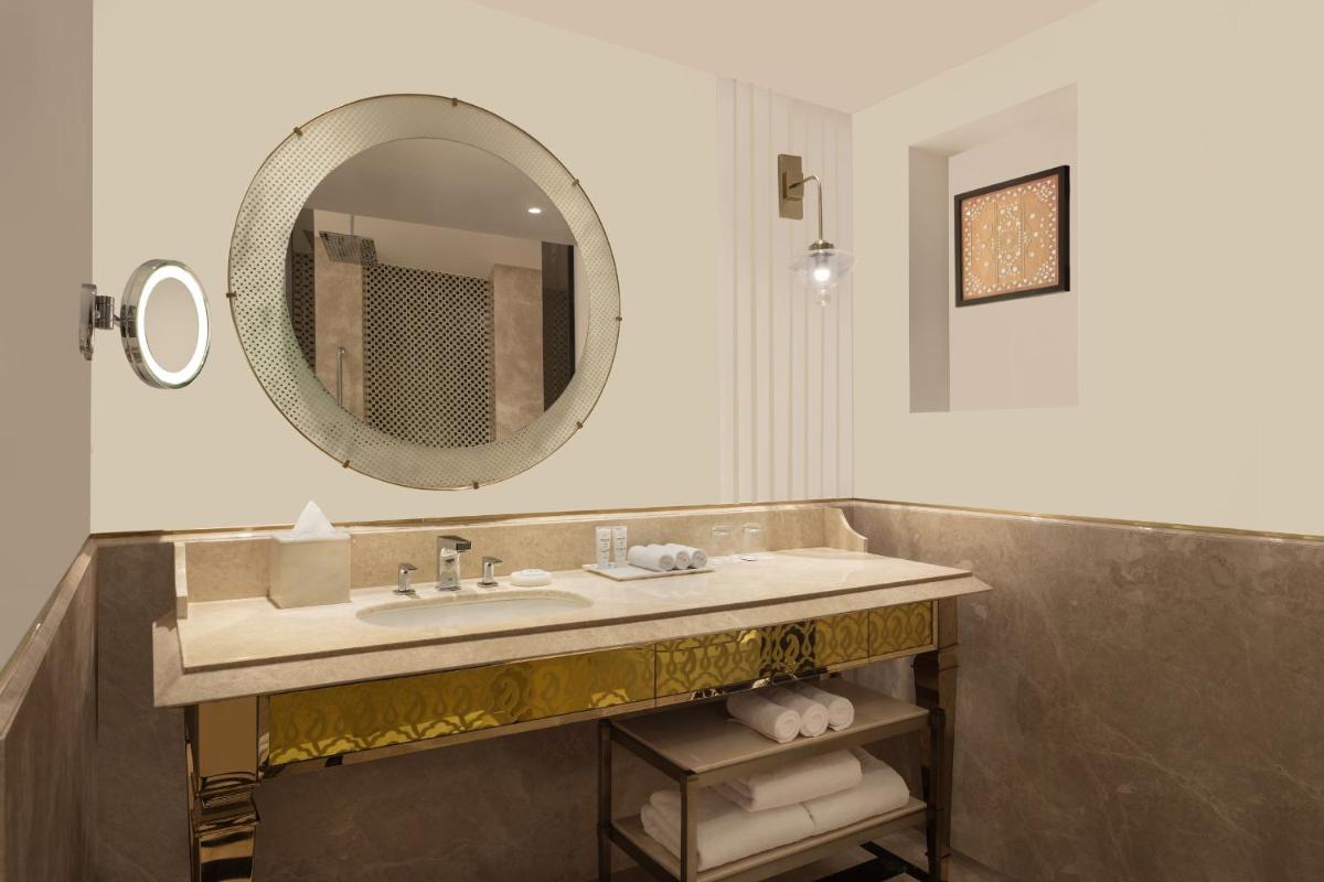 a bathroom with a sink and a mirror at ITC Narmada, a Luxury Collection Hotel, Ahmedabad in Ahmedabad