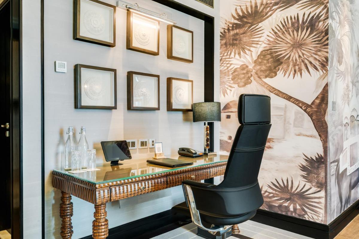 a home office with a desk and a chair at ITC Narmada, a Luxury Collection Hotel, Ahmedabad in Ahmedabad