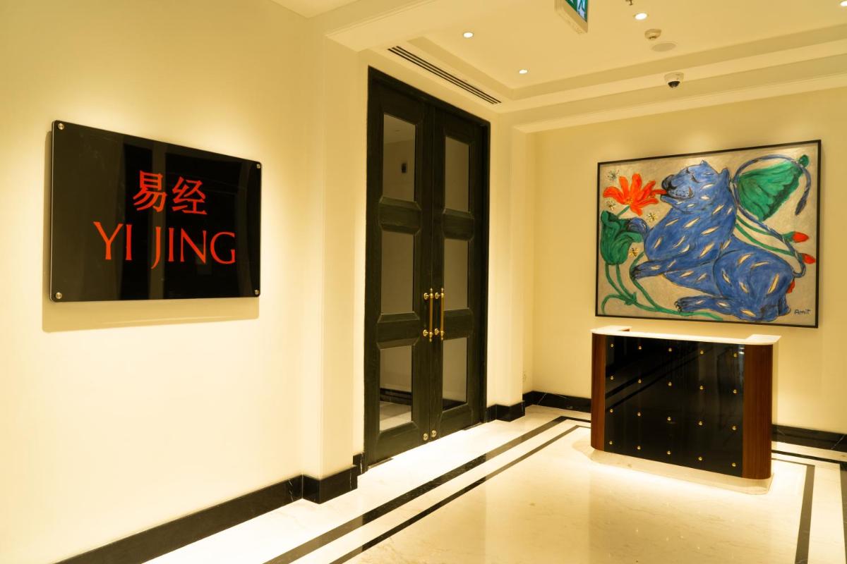 a room with a door and paintings on the wall at ITC Narmada, a Luxury Collection Hotel, Ahmedabad in Ahmedabad