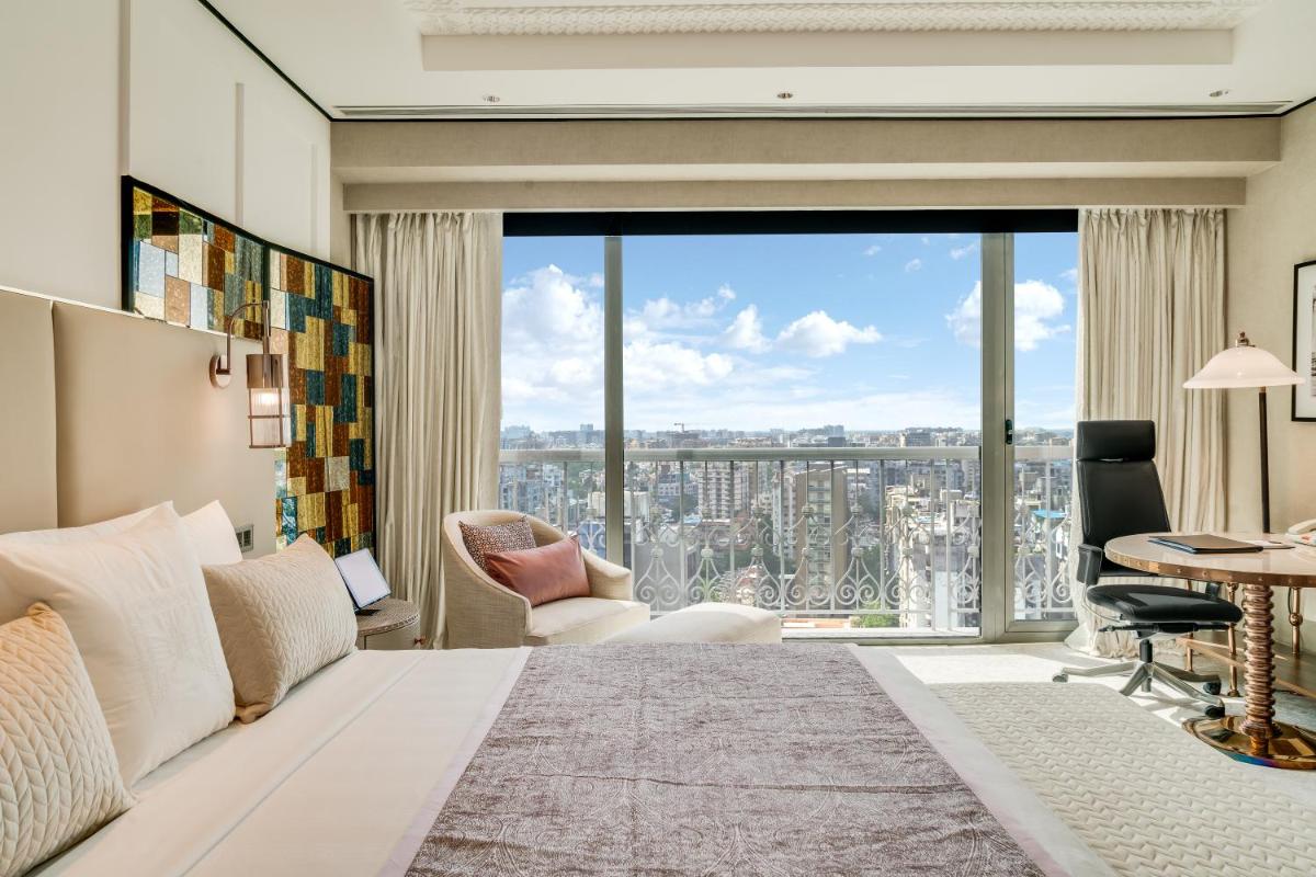 a bedroom with a bed and a large window at ITC Narmada, a Luxury Collection Hotel, Ahmedabad in Ahmedabad