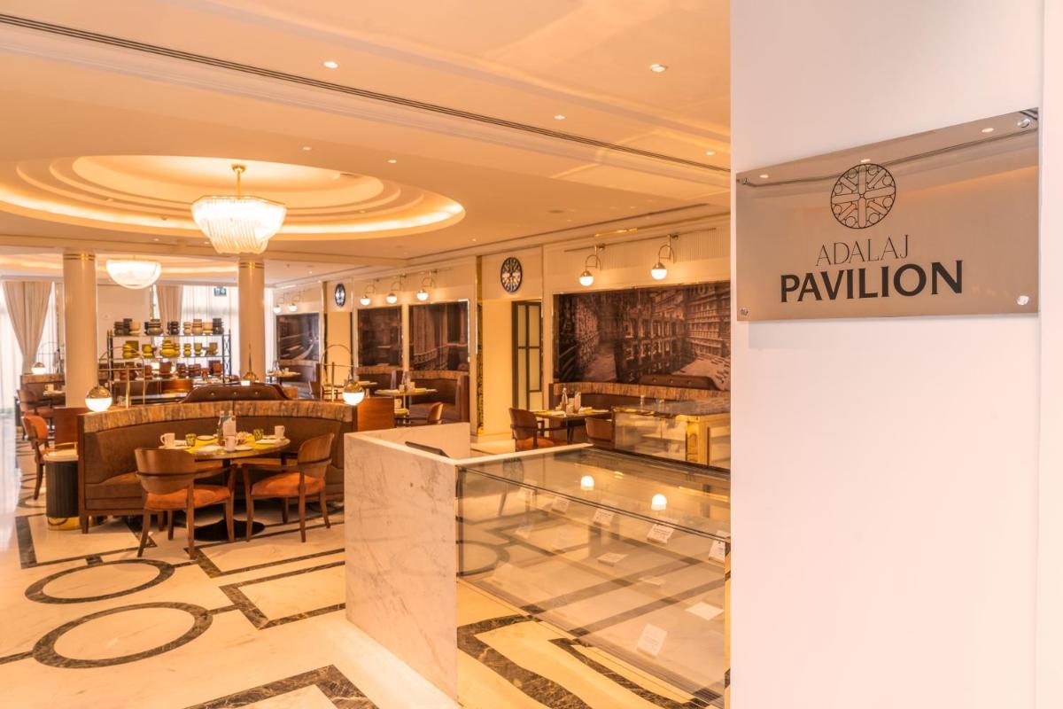 a restaurant with a table and chairs in a room at ITC Narmada, a Luxury Collection Hotel, Ahmedabad in Ahmedabad