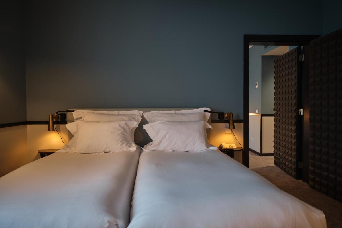 Uma cama ou camas num quarto em Octant Lousa