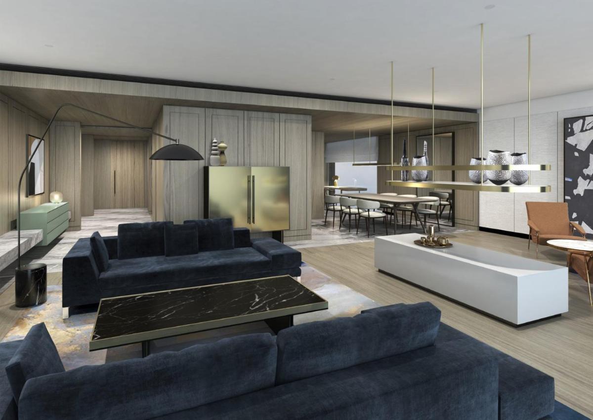 a living room with blue couches and a dining room at Taj The Trees, Mumbai in Mumbai