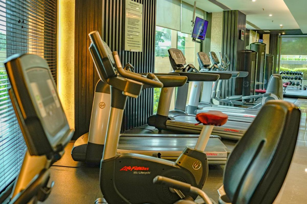 a gym with a row of treadmills at Courtyard by Marriott Gurugram Downtown in Gurgaon